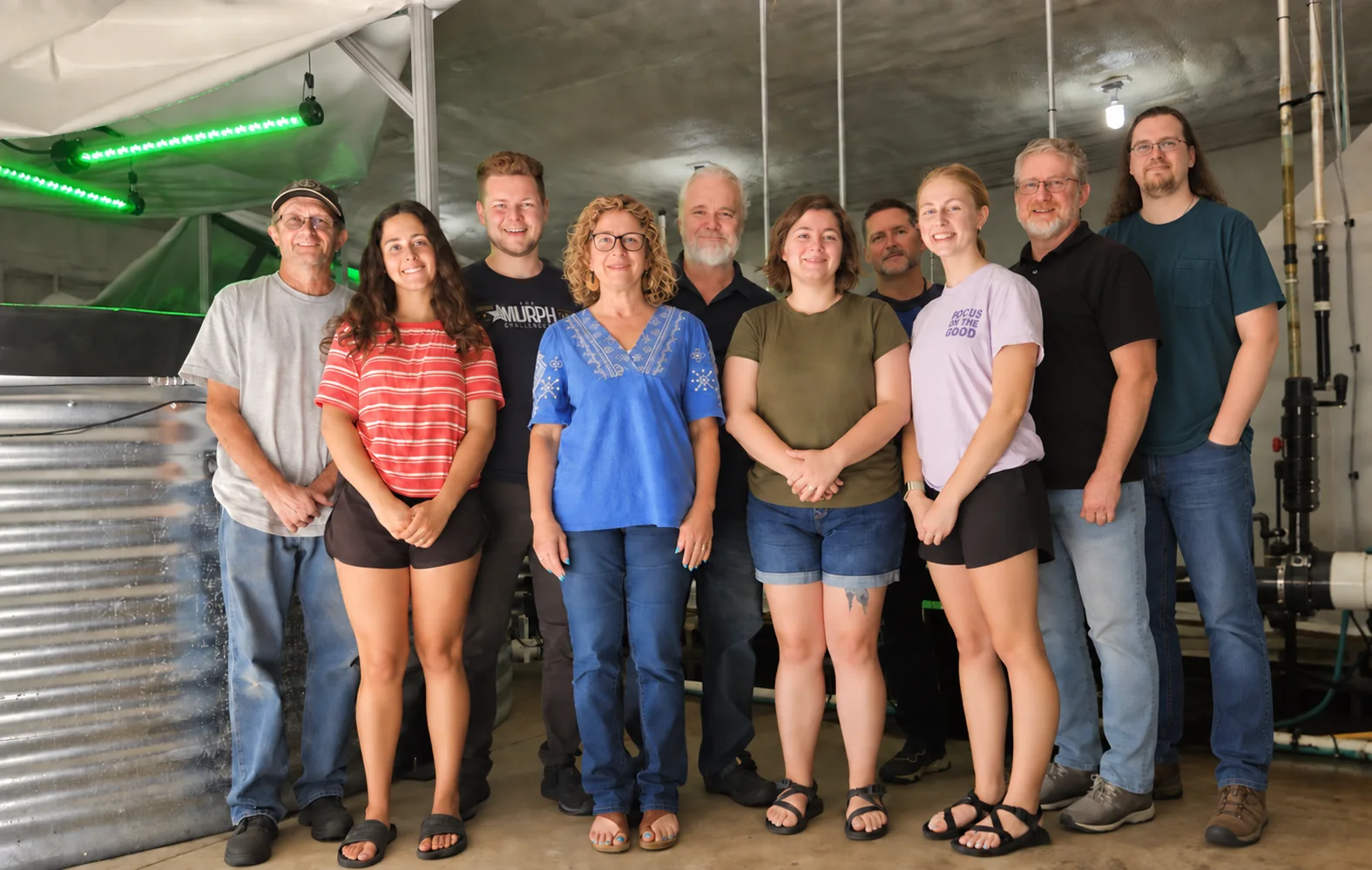 Members of the Morning Glory Valley and PurBlu community gathered inside the growing facility.